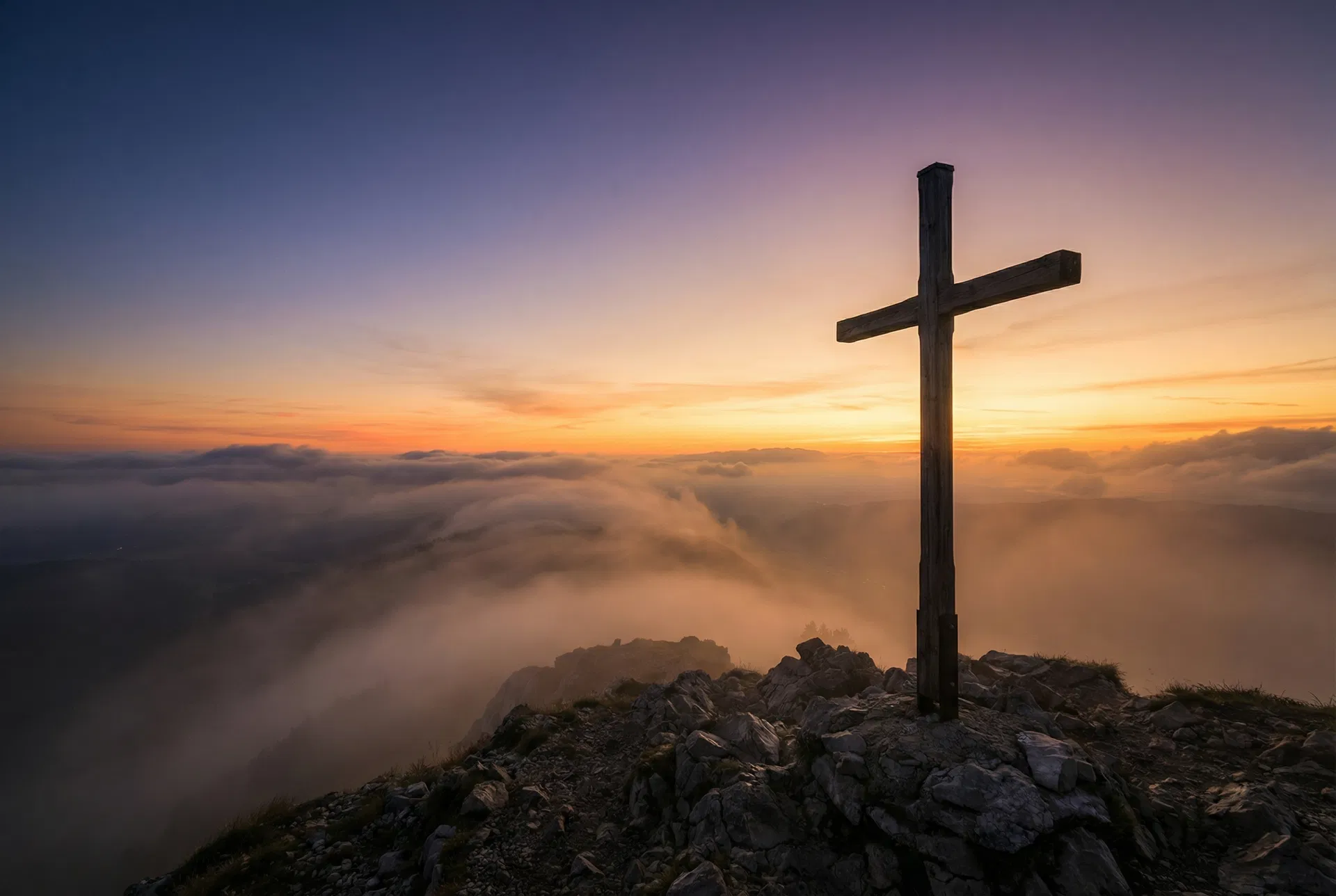 Cross on mountain at sunrise